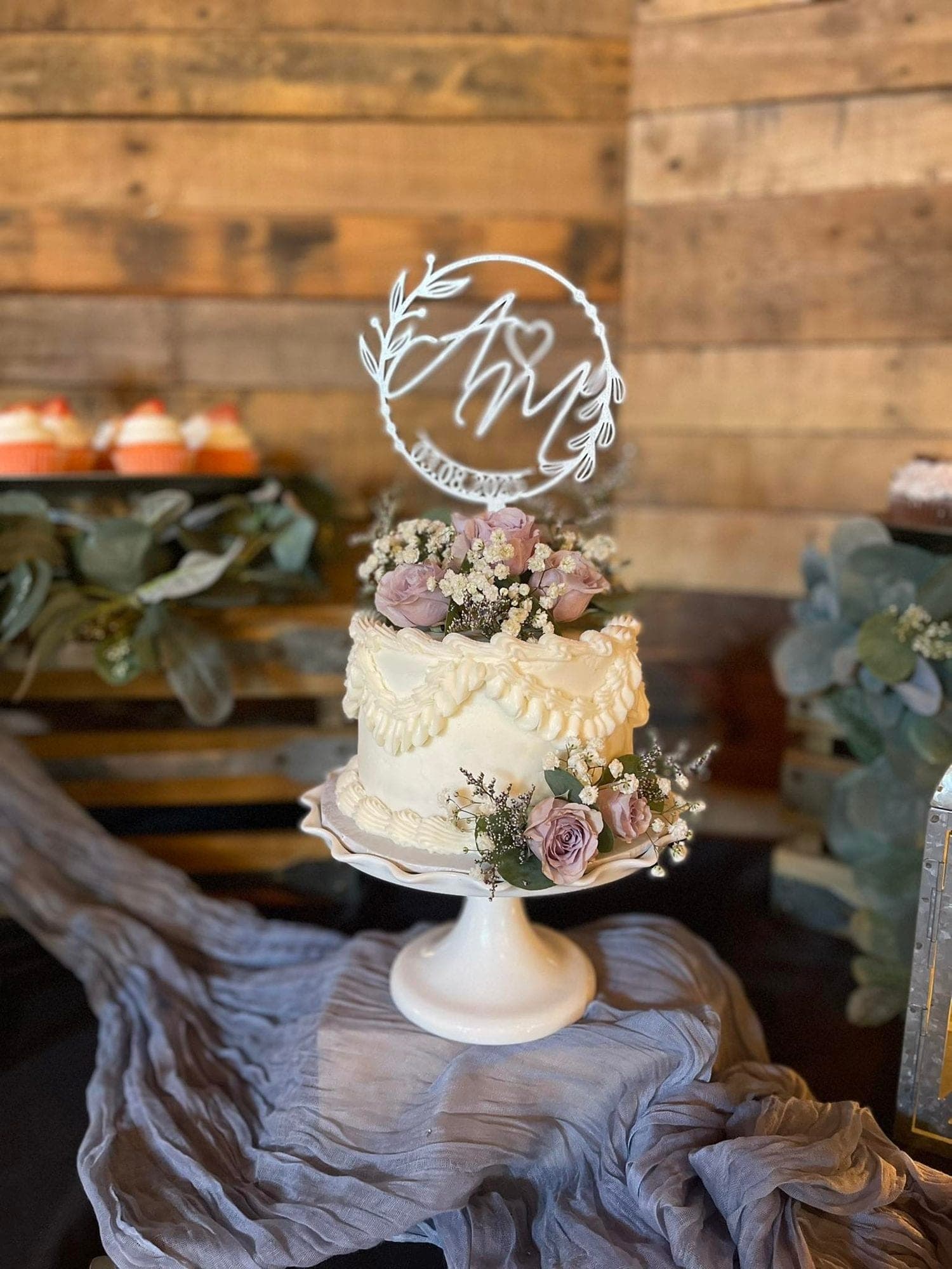 Elegant white wedding cake with a floral topper